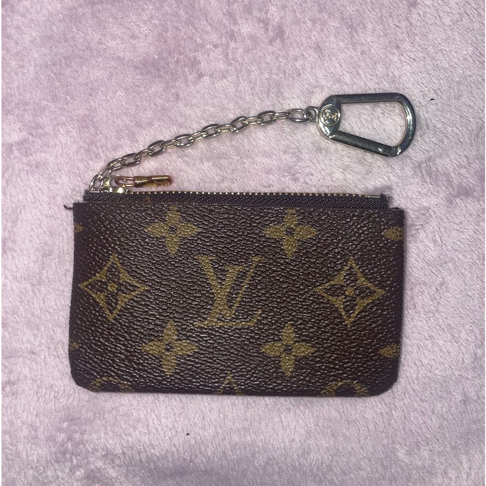 COPY - The Louis Vuitton card holder with a zipper is a sleek and luxurious acc…